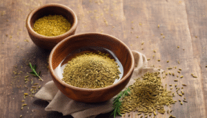 A warm glass of cumin seed water served in a transparent cup, placed next to a healthy Indian meal of rice and dal, symbolizing improved digestion and weight loss. Soft focus background showing a happy person enjoying light Indian food."