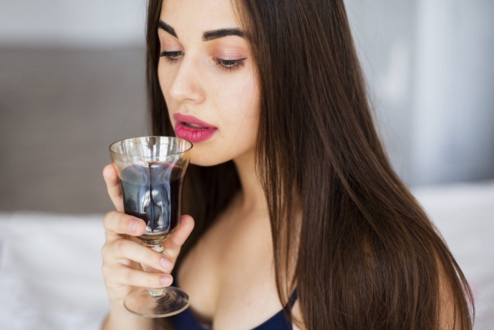 A glowing skin girl is drinking shilajit in water. indicate shilajit benefits for skin