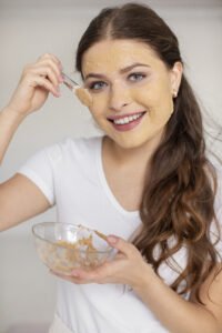 a girl apply product on her face
