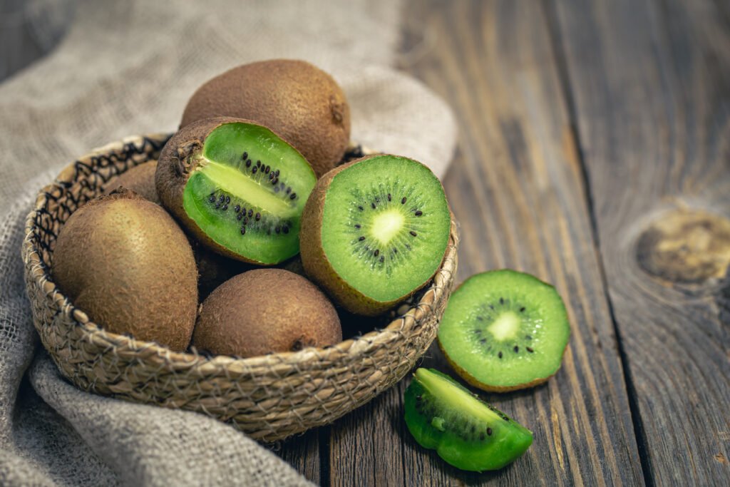 Close -up, cut fruit kiwi on a wooden background, rustic style.